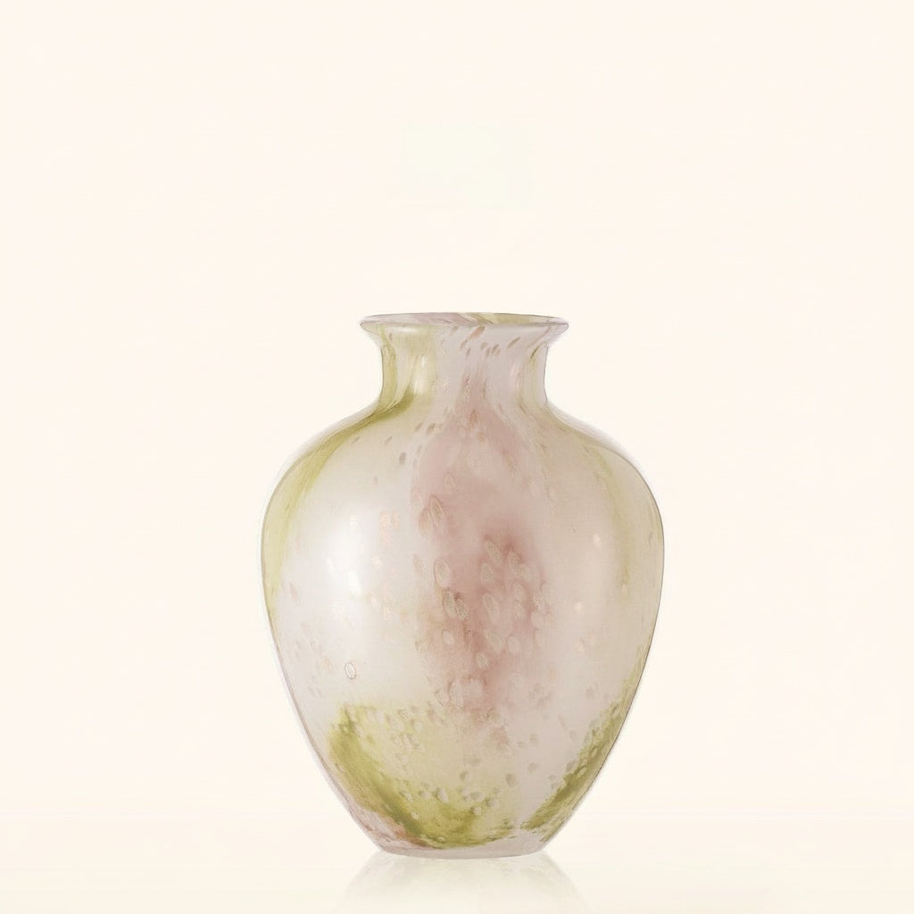 Mottled art glass bulbous vase with pink and green tones on a light background.
