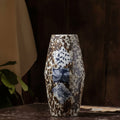 Front view of mottled brown and blue patterned ceramic vase