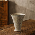 Mottled glaze ceramic flared vase on wooden table