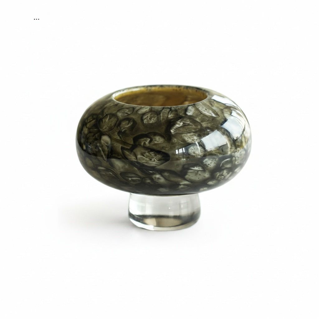 Close up of wide art glass bowl with organic dark pattern and clear base