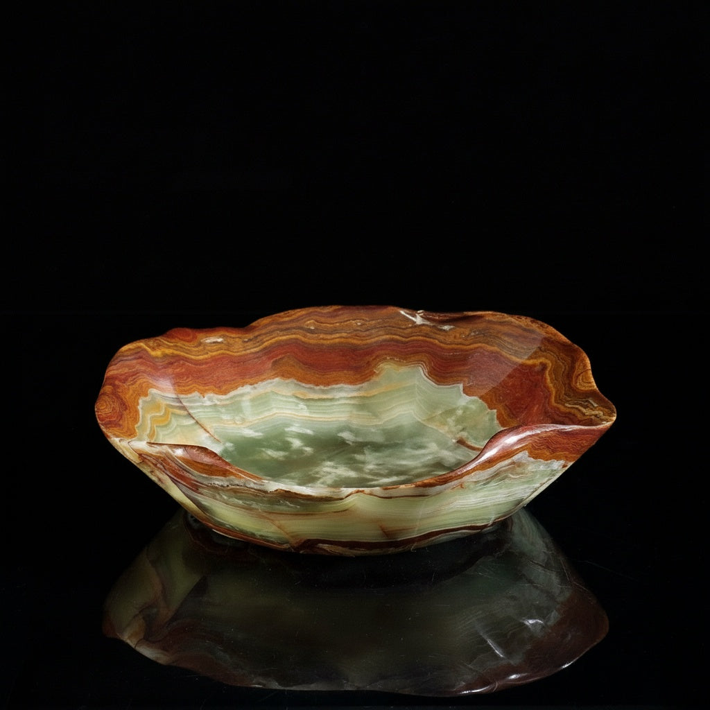 Side view of multi-color marble bowl with organic wavy rim on black background