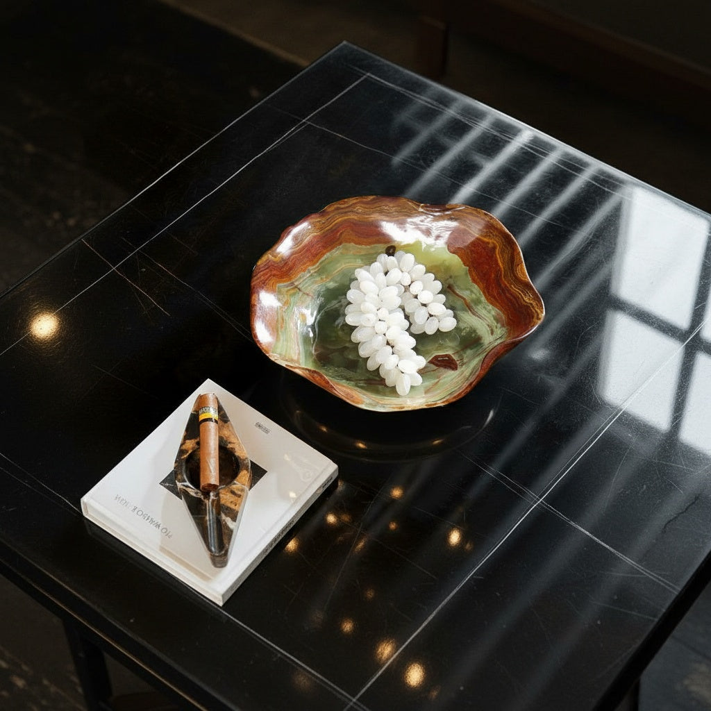 Lifestyle shot of marble bowl holding white grapes on a luxury dark table