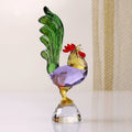 Full view of faceted crystal rooster figurine with purple body and green tail