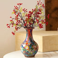 Multicolor art glass vase styled with red berries