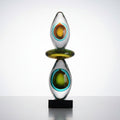Front view of multicolor art glass sculpture with teal and amber details