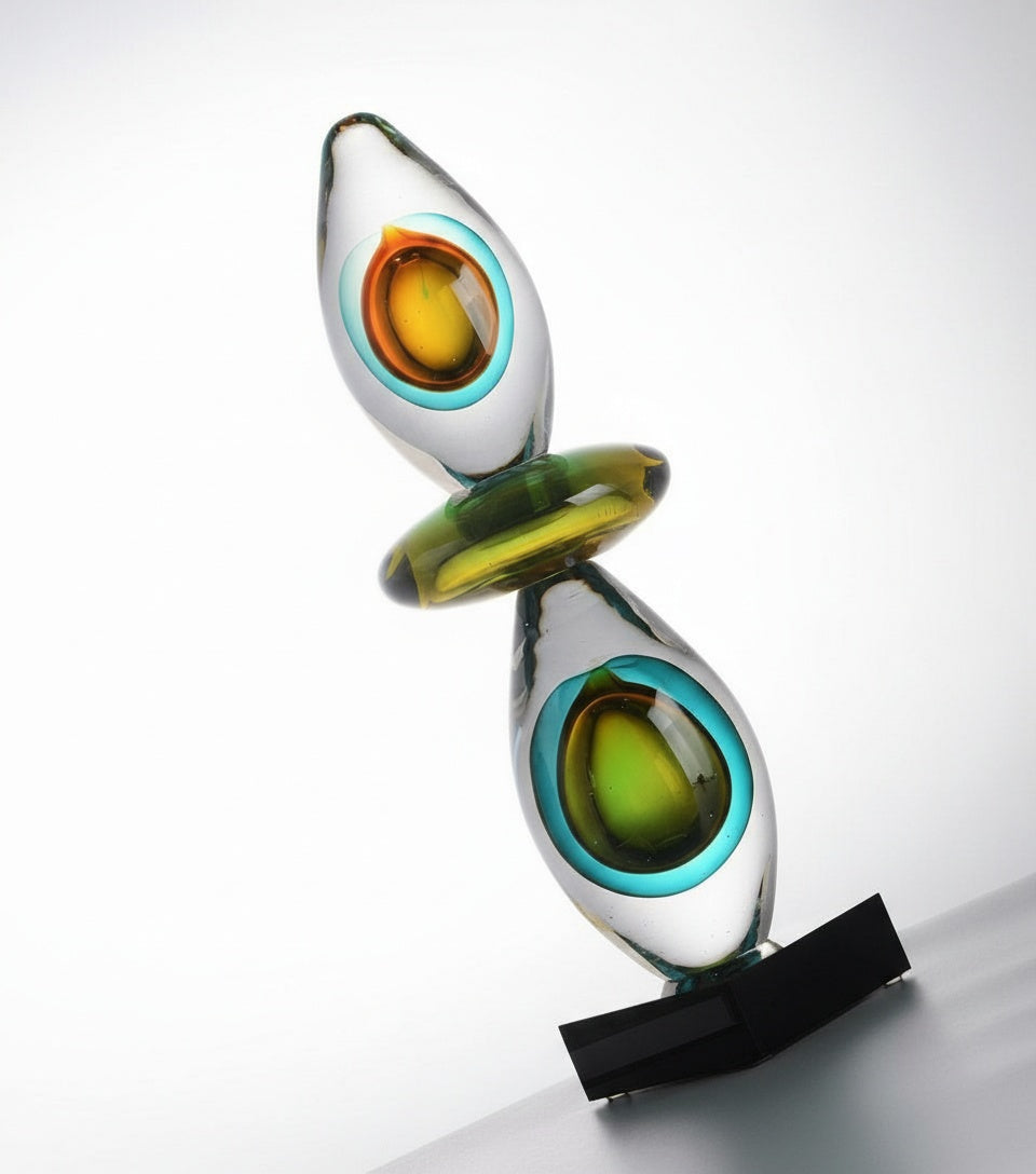 Angled view of geometric art glass sculpture showing depth and color