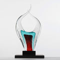 Front view of multicolor glaze abstract flame sculpture on black base