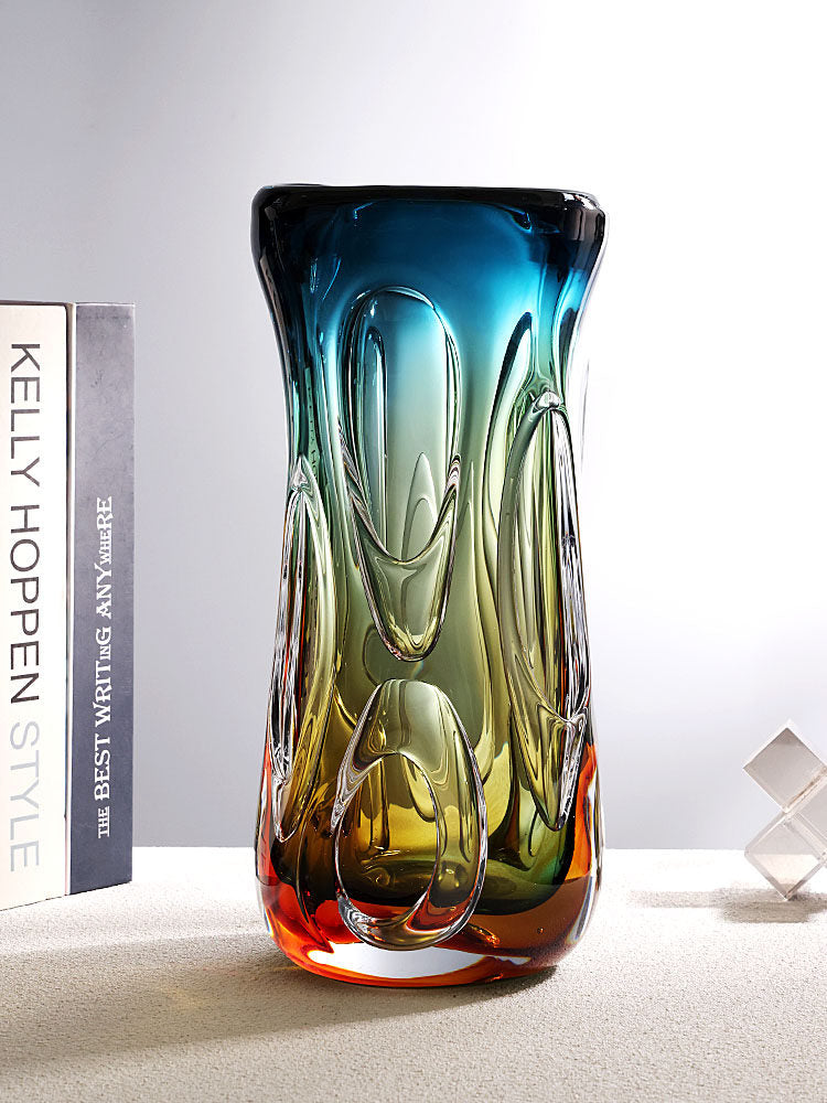 Lifestyle context of the art glass vase on a table next to books