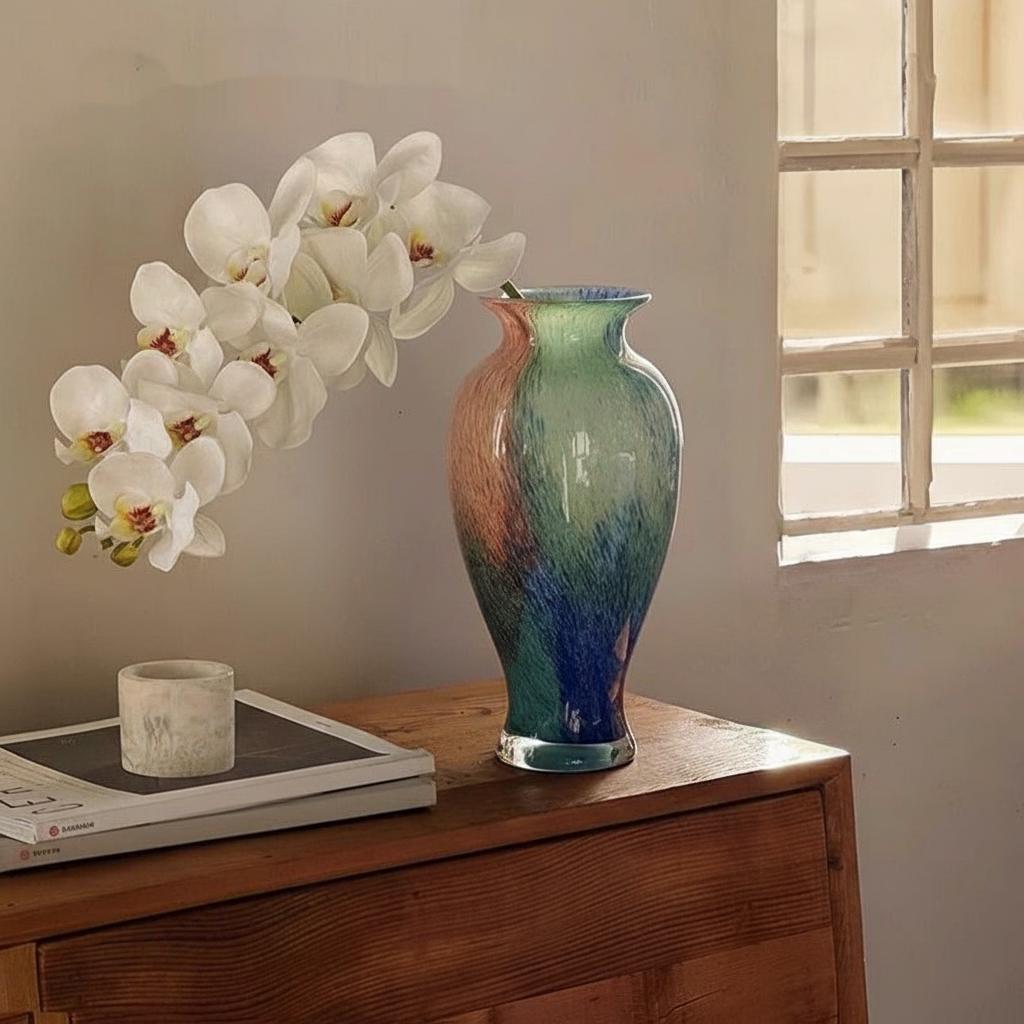 Side view of multicolor speckled glass vase on wooden surface