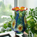 Front view of multicolored floral art glass vase on table