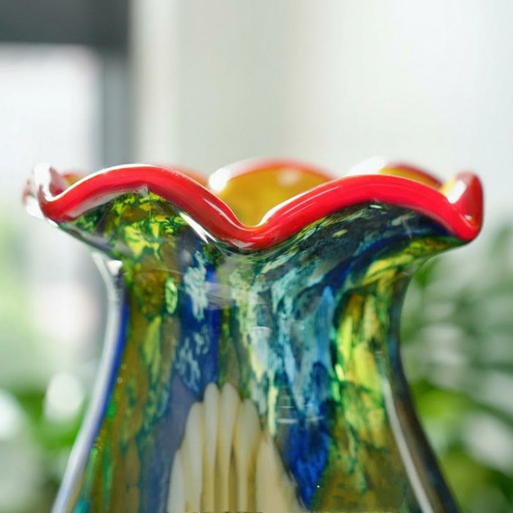 Close up detail of red ruffled rim and yellow interior of glass vase