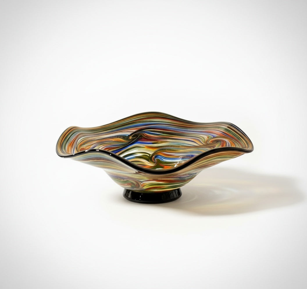 Front view of multicolored art glass centerpiece bowl on black base