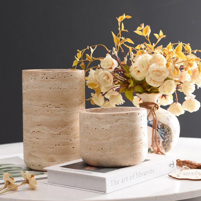 Natural cave stone cylindrical vase with floral arrangement