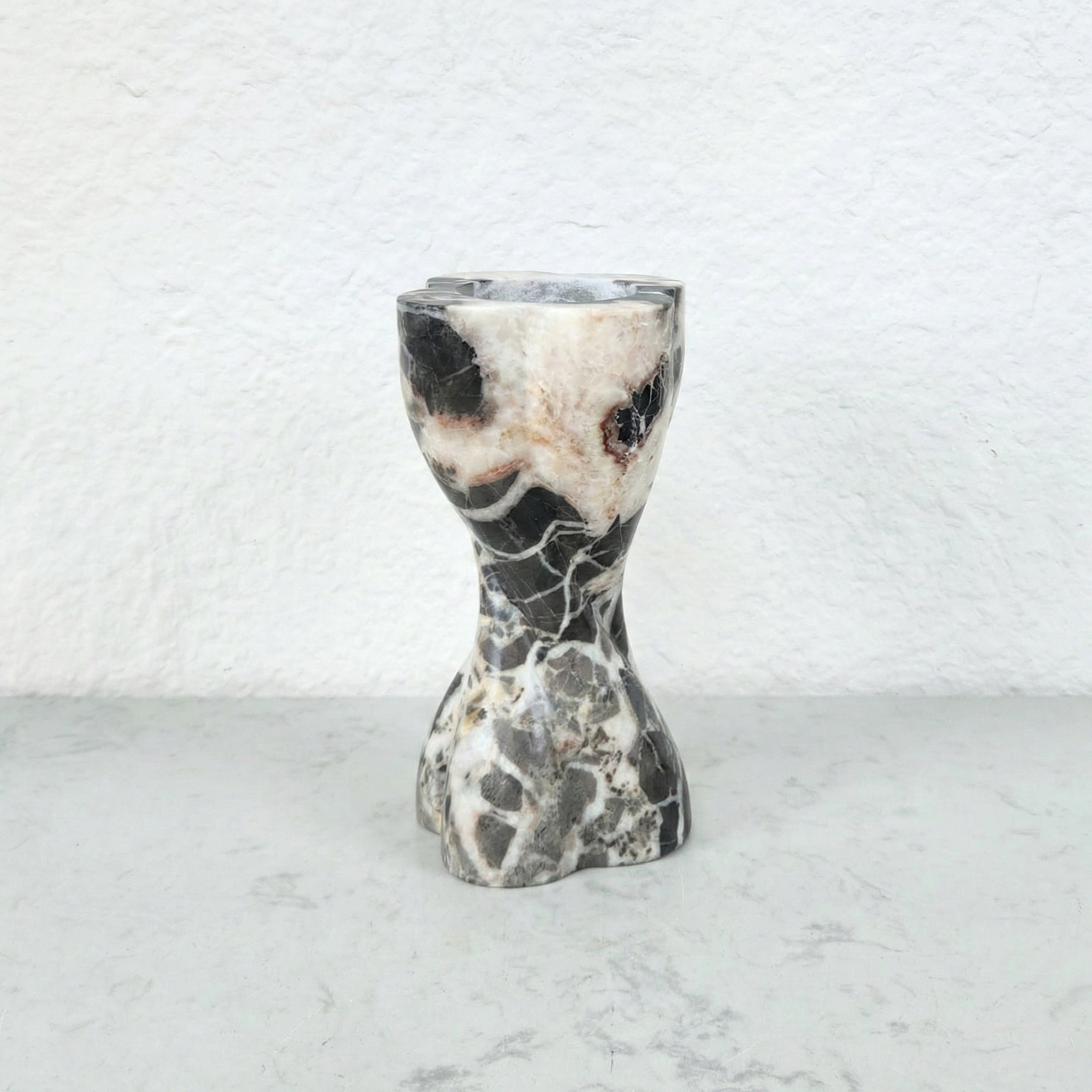 Detail view of white and gray mixed marble candle holder