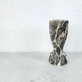 Detail view of dark gray marble candle holder