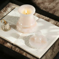 Natural onyx chess pawn candle holder glowing on a book