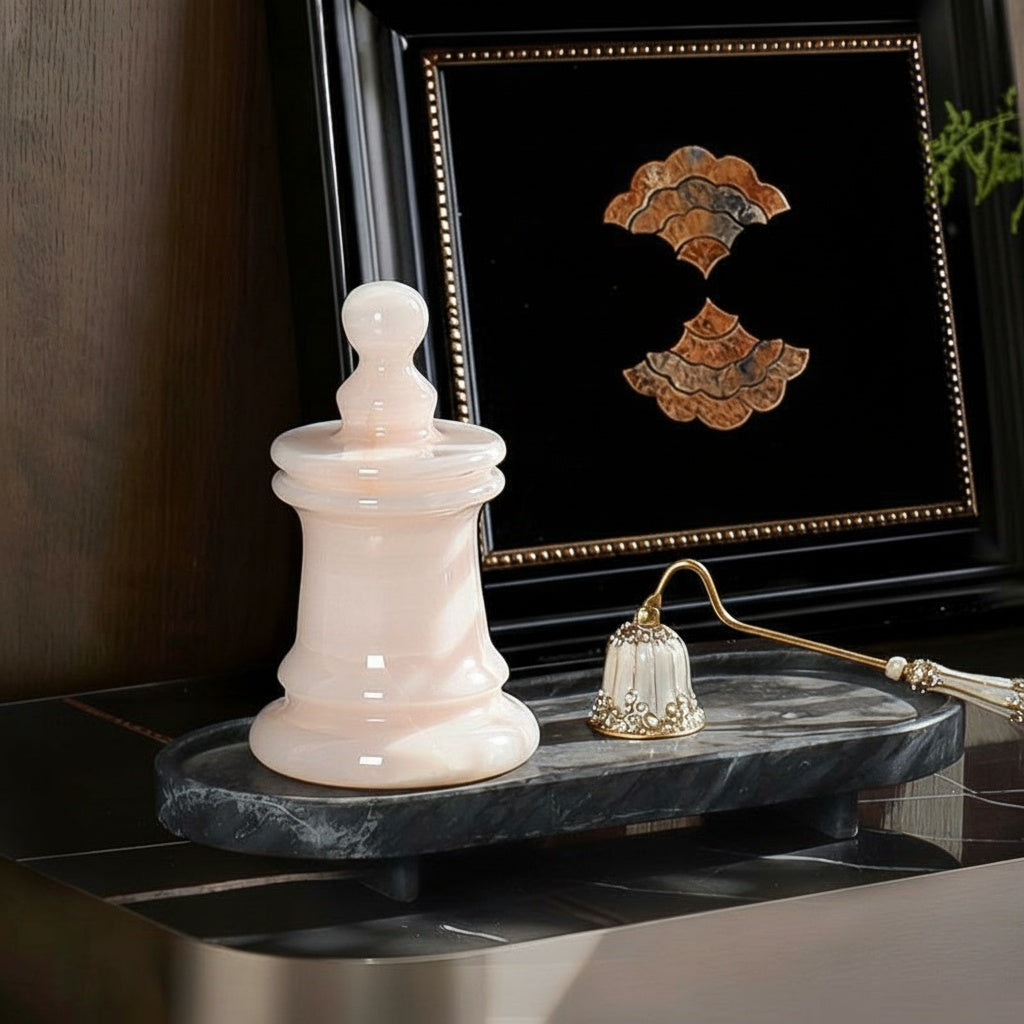 Luxury blush onyx chess piece candle holder on a marble tray