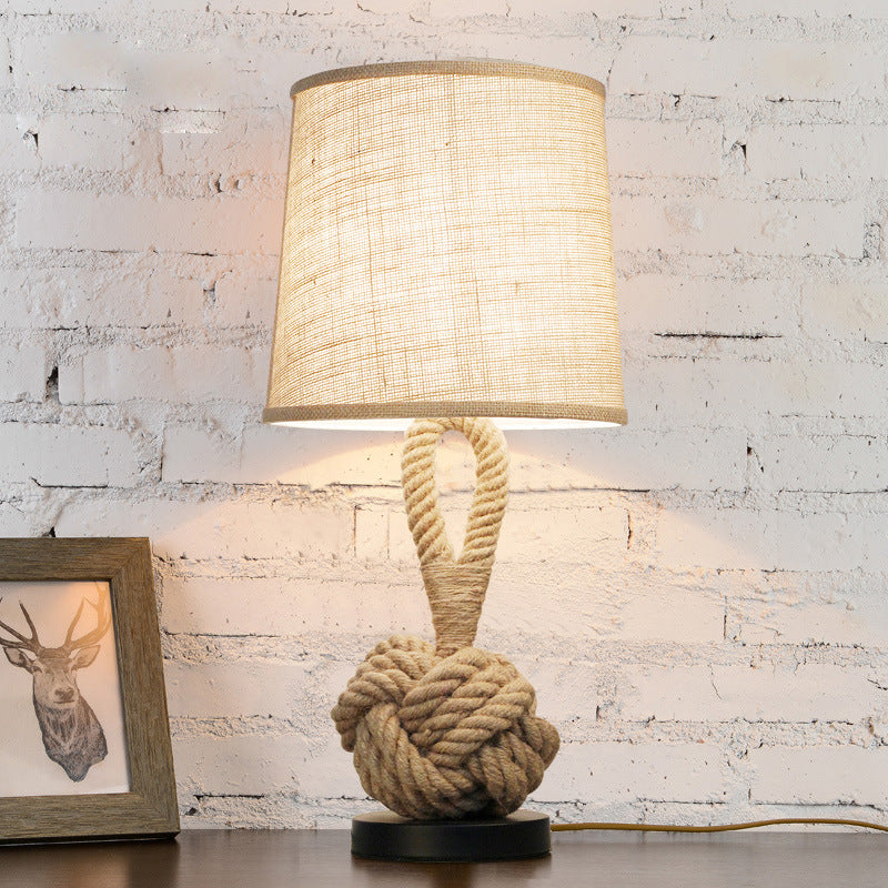Nautical style rope knot lamp against white brick wall
