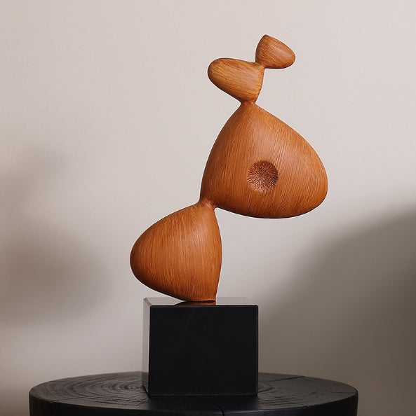 Front view of wood abstract sculpture on black base