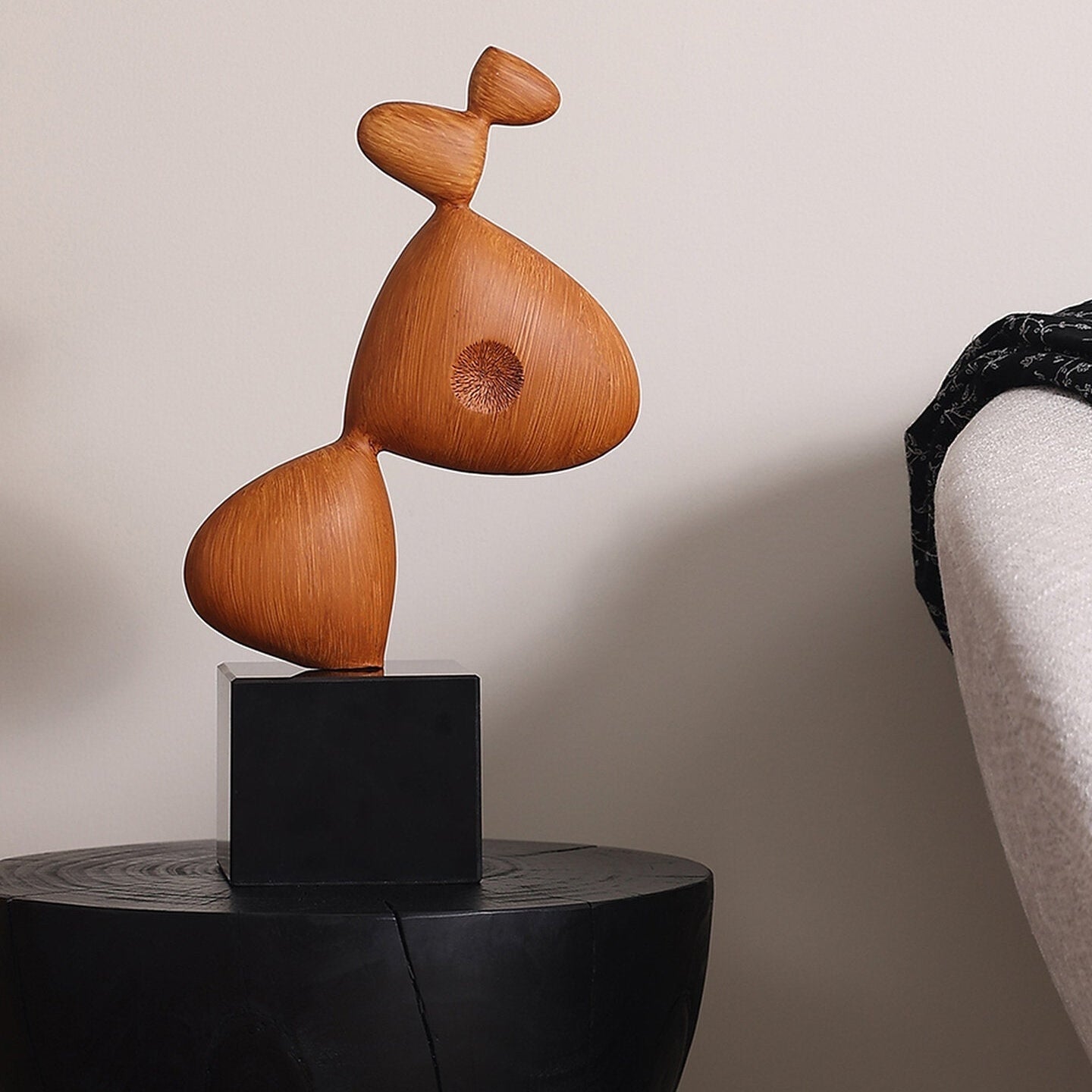 Side profile of organic wood sculpture showing grain texture