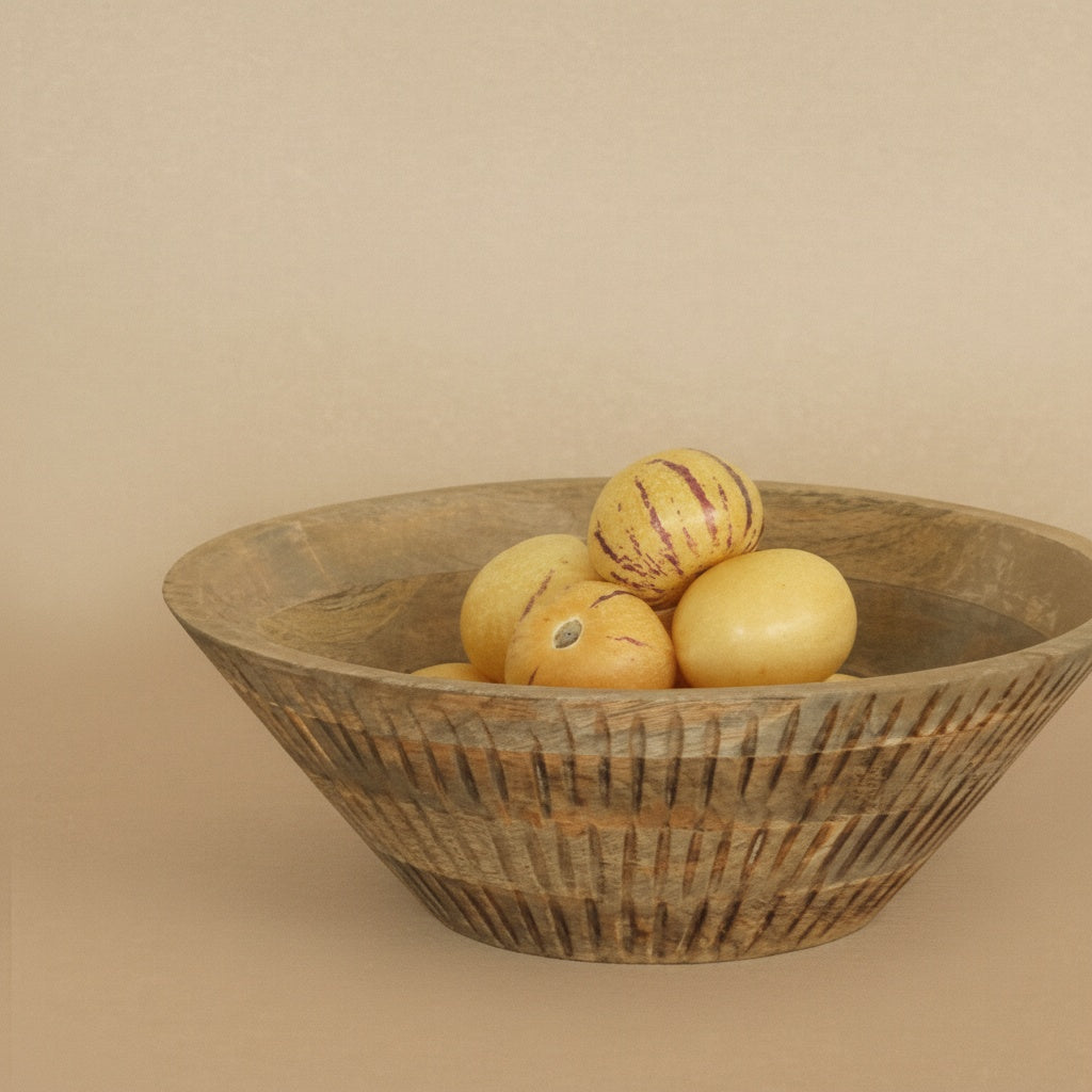 Side view of textured wood bowl with fruit