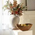 Styled wooden bowl with flowers and lemons