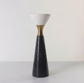 Front view of single tall black marble candle holder with white stone cup