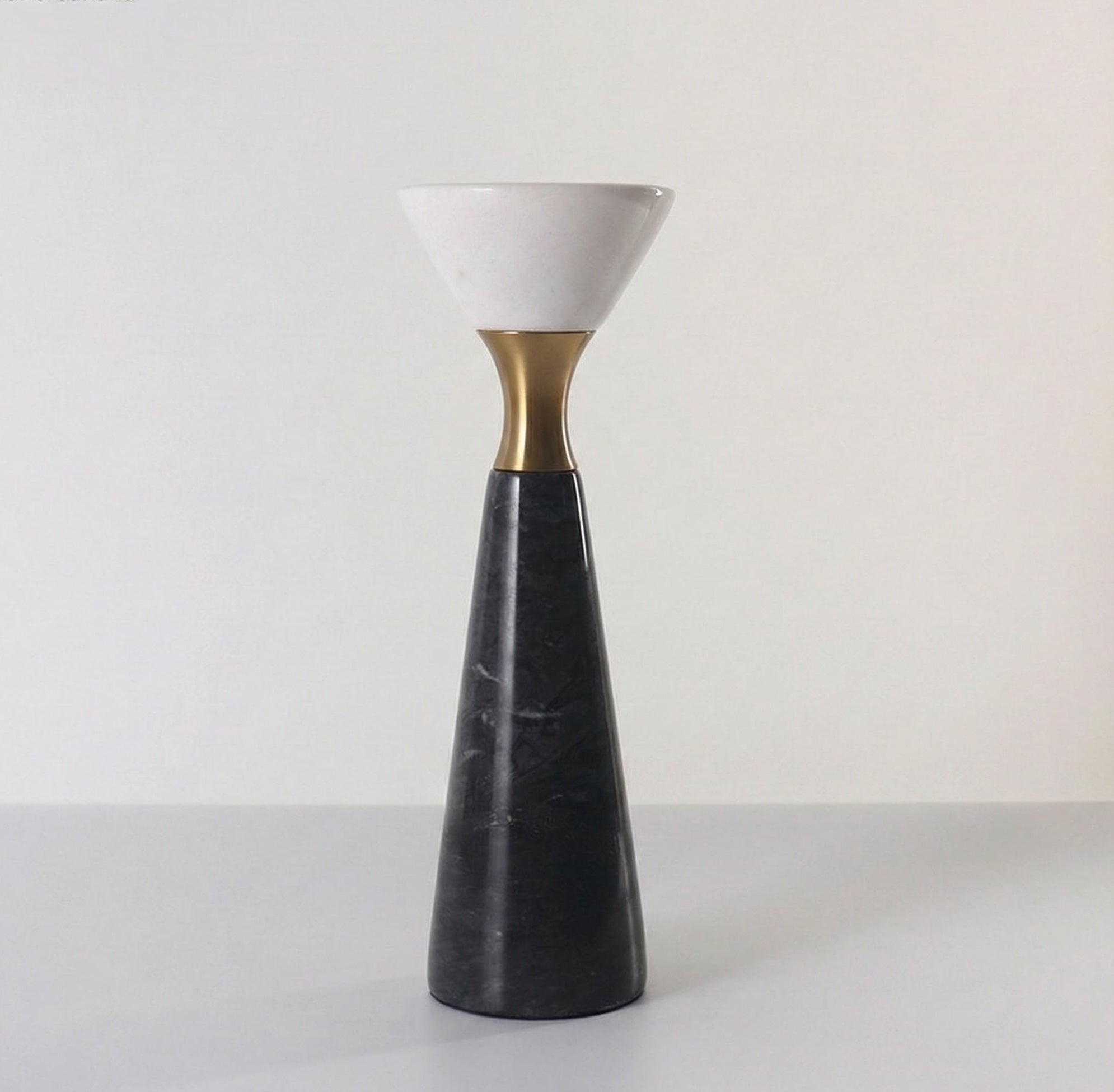 Front view of single tall black marble candle holder with white stone cup