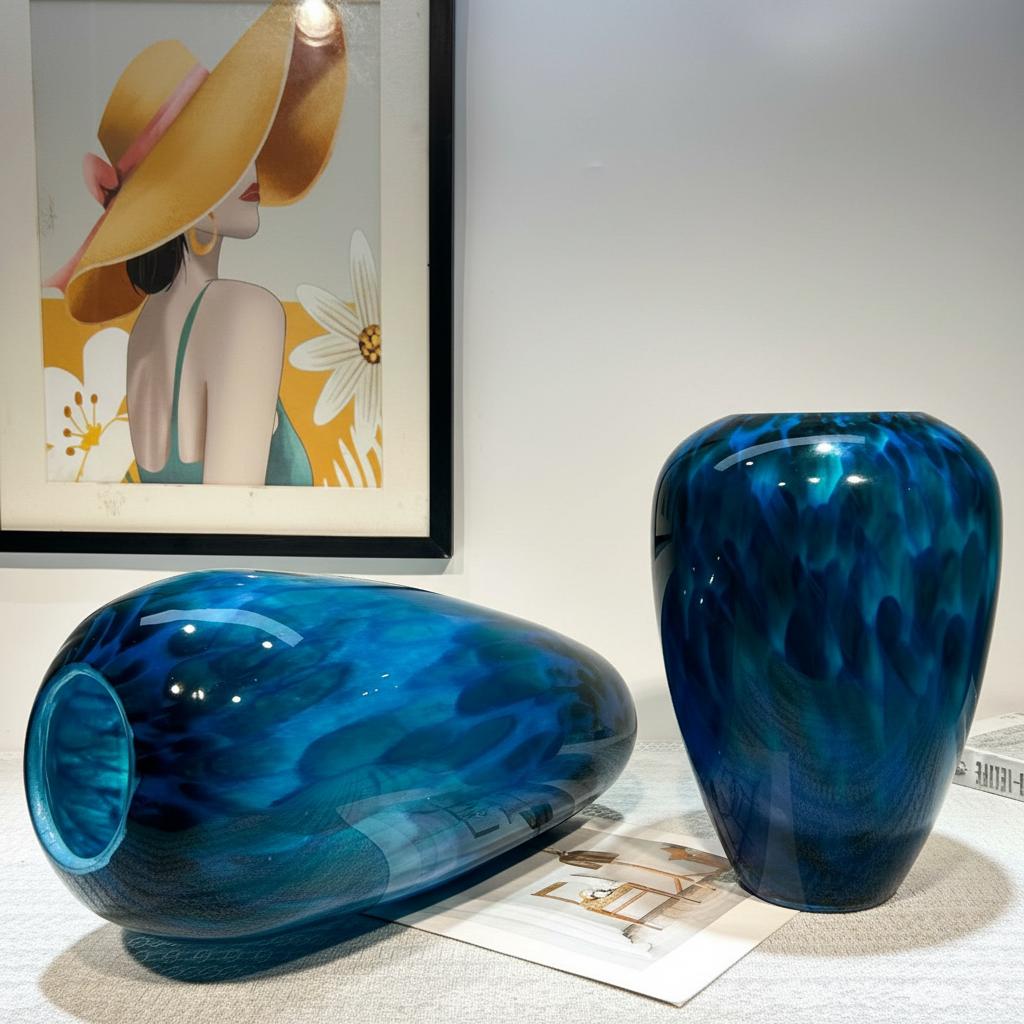 Angled view of large and medium blue glass vases