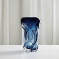 Close up of single blue gradient wavy glass vase