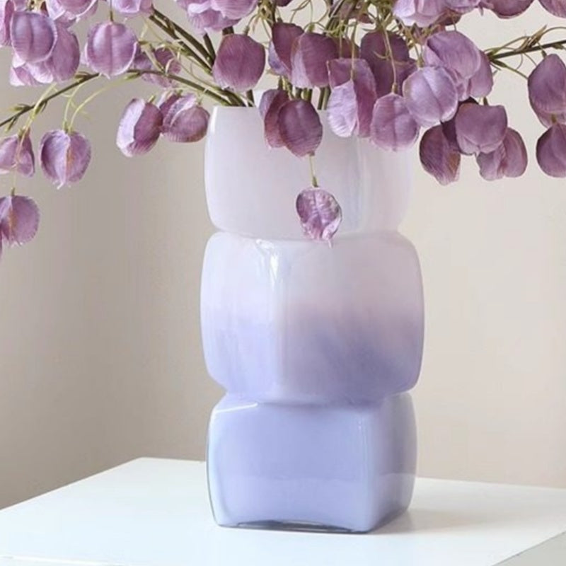 Detail of purple gradient glass vase with dried flowers