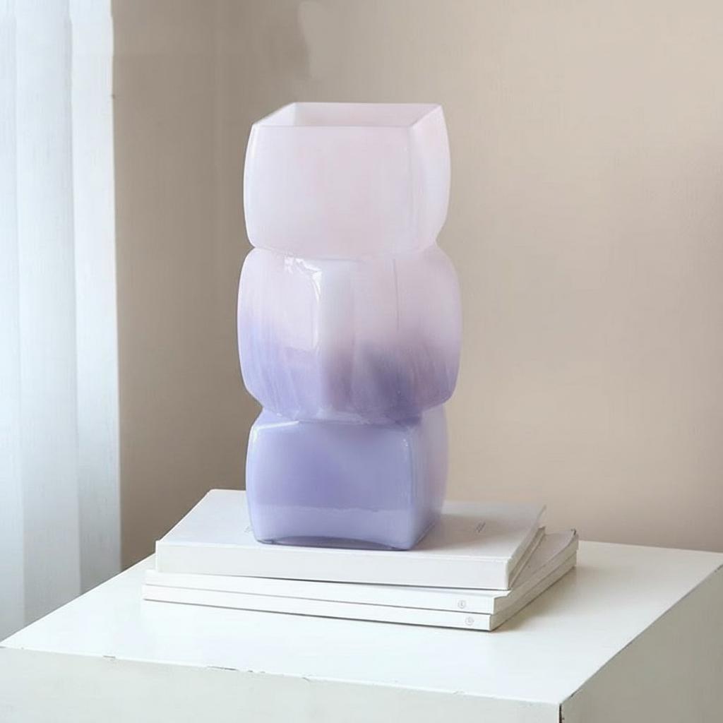 Full view of stacked geometric glass vase on books