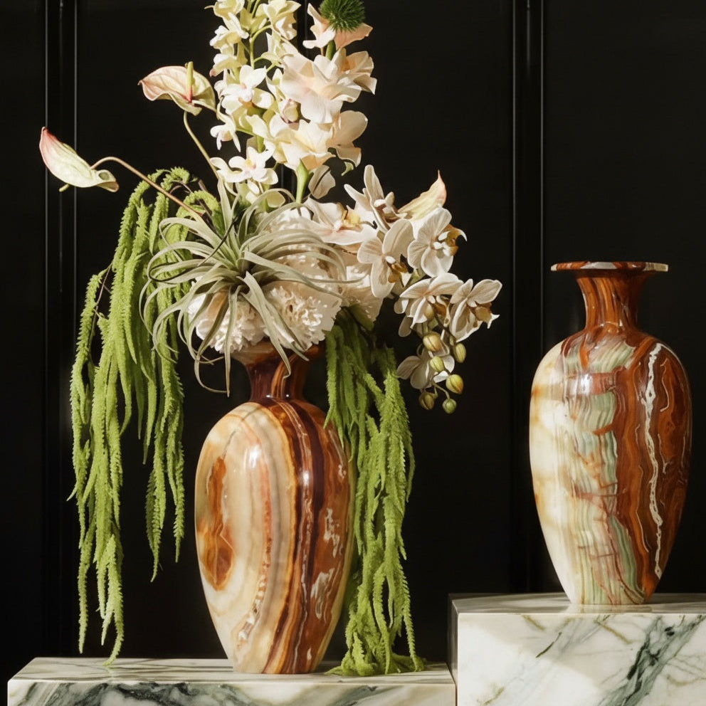 Hand touching surface of polished onyx marble vase