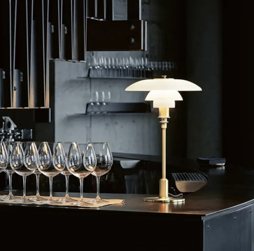 Brass finish layered shade table lamp on bar counter