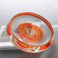 Angled top view showing internal orange swirls in glass bowl