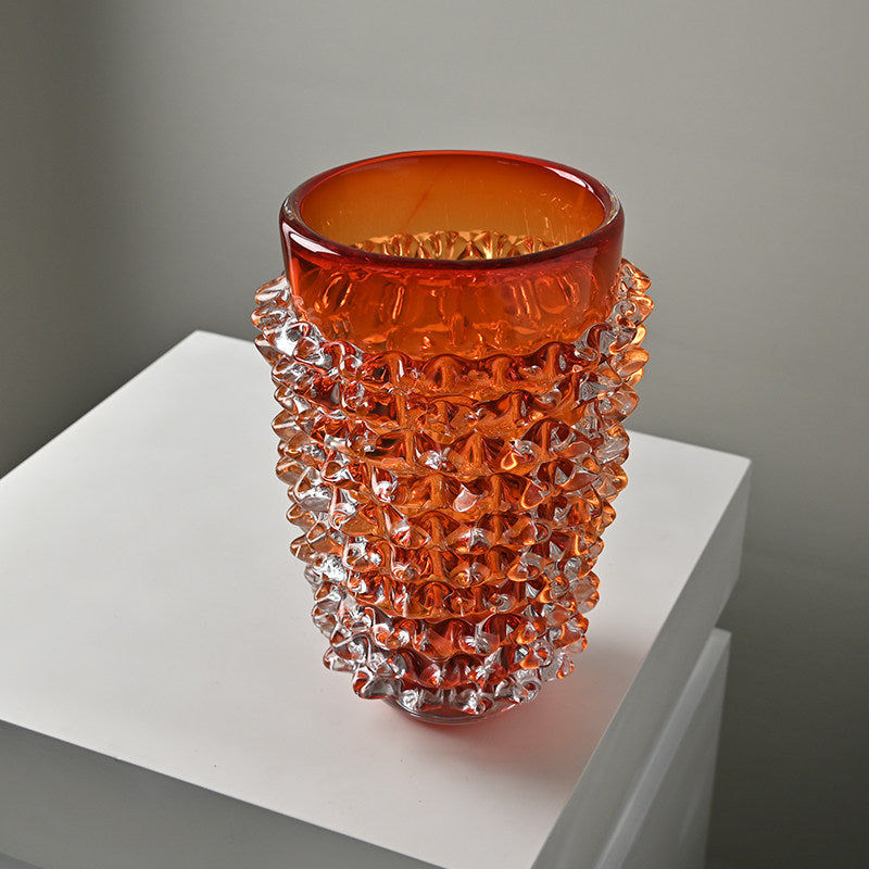 Detail of orange spiked glass vase texture and rim