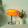 Angled view of orange glass lamp with chrome base