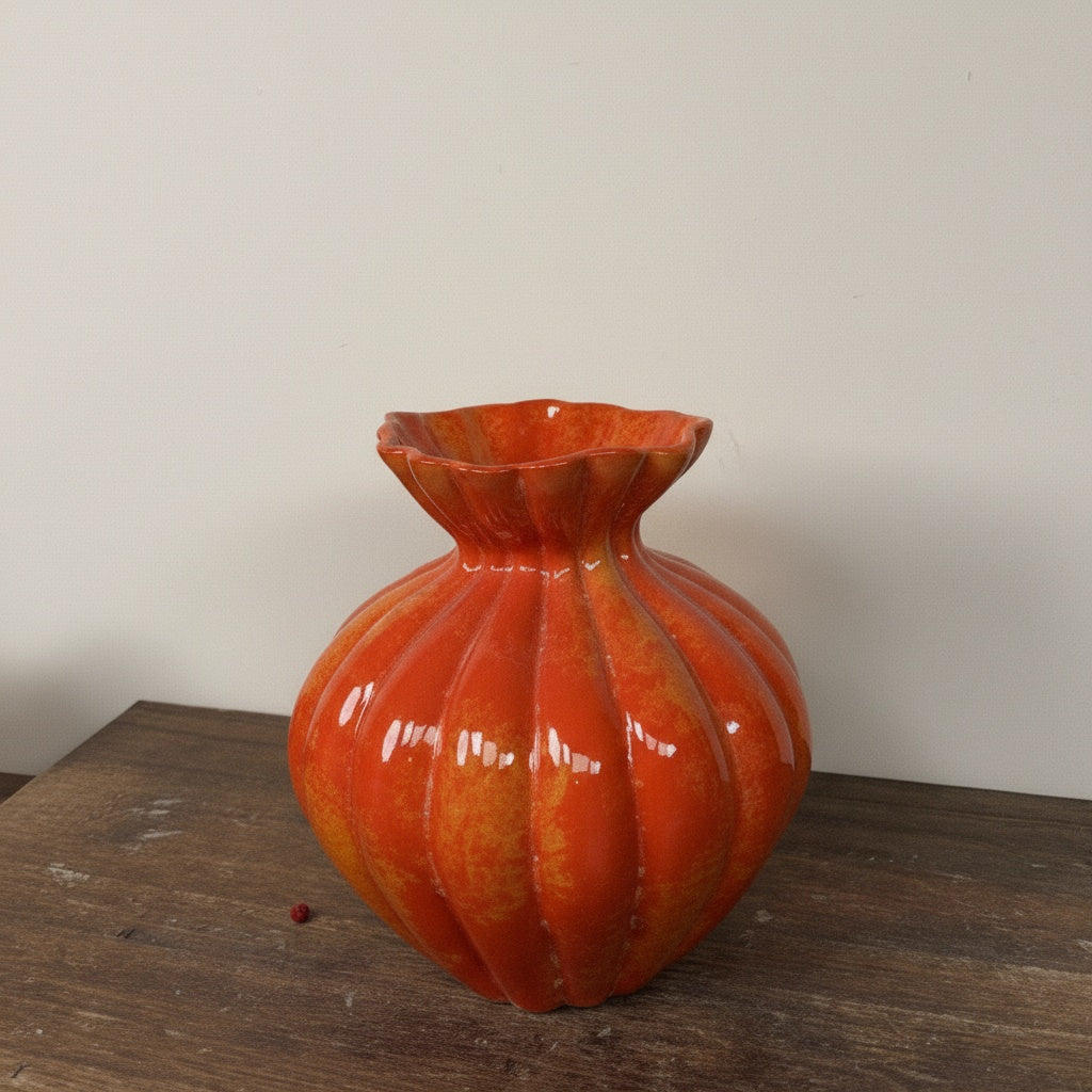 Orange glazed fluted ceramic vase with ribbed texture
