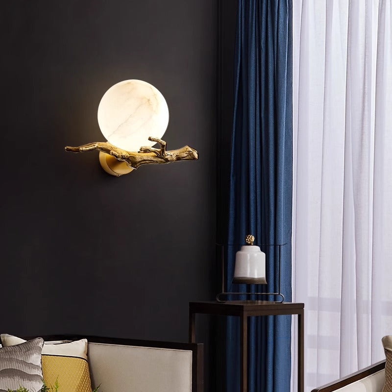 Modern organic wall light installed on a dark wall providing warm ambient glow in a living space