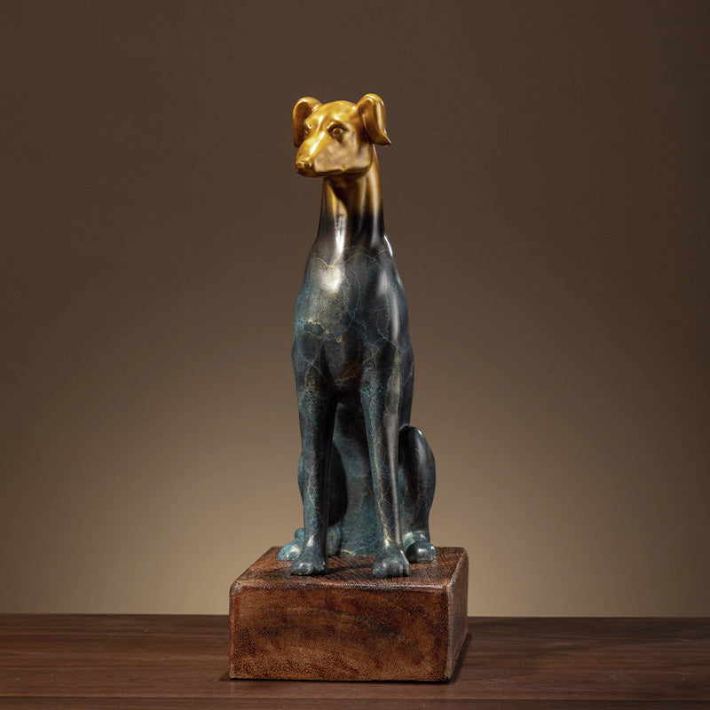 Front view of seated greyhound sculpture with gold head and blue patina body