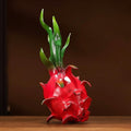 Front view of the painted brass dragon fruit sculpture