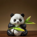 Front view of painted copper panda figurine