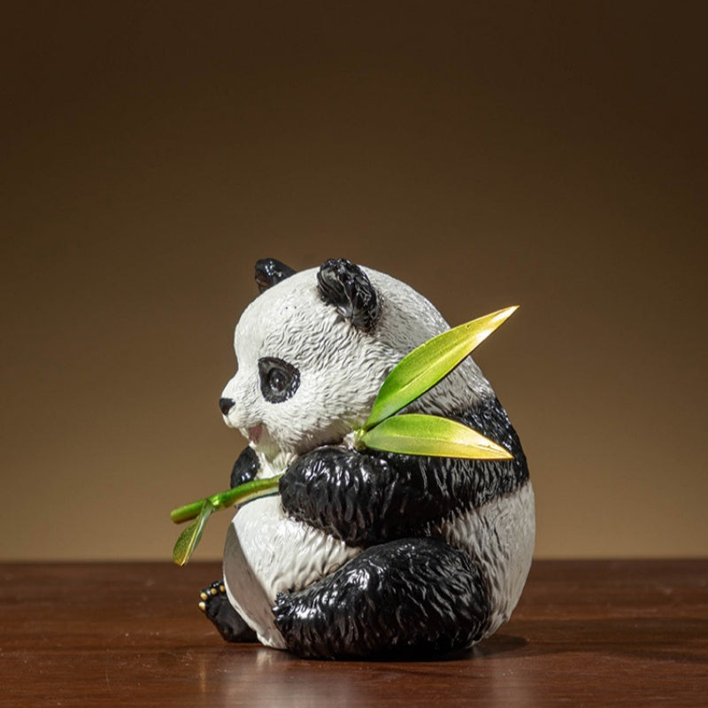 Side profile of panda holding bamboo