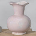 Front view of pale pink ceramic vase with ruffled rim