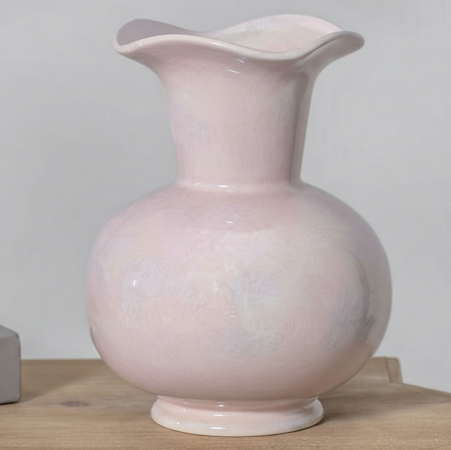 Front view of pale pink ceramic vase with ruffled rim