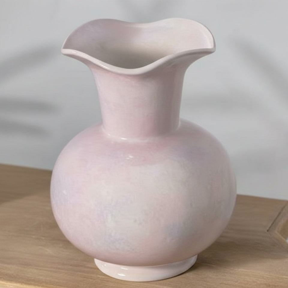 Angled view of blush pink glazed vase