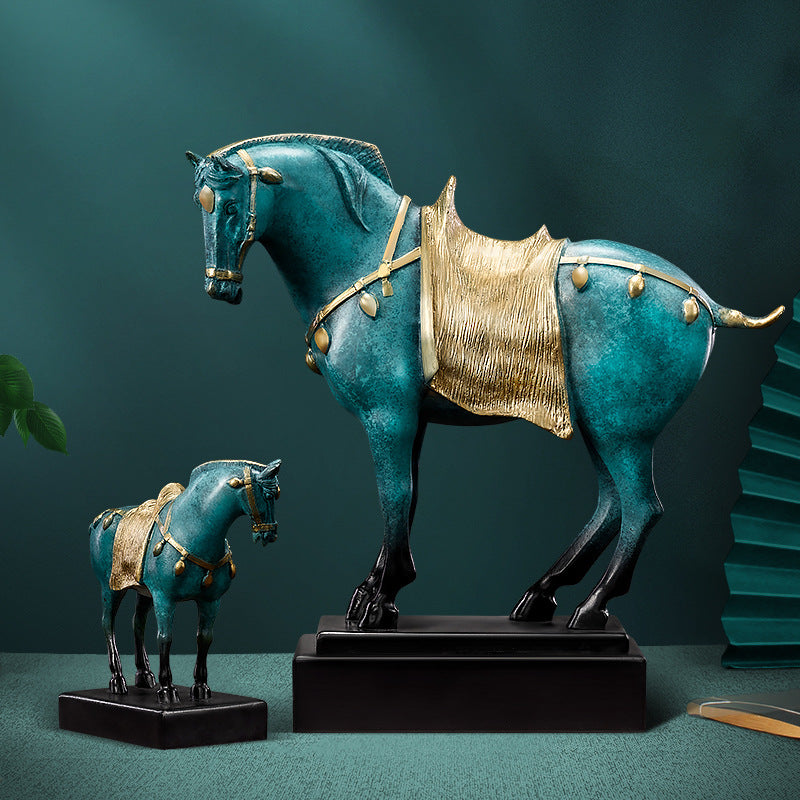 Two patina copper horse sculptures standing side by side