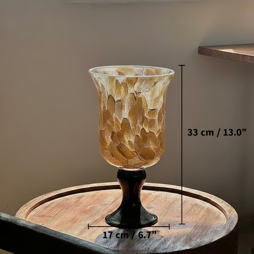 Brown art glass vase on table in sunlight