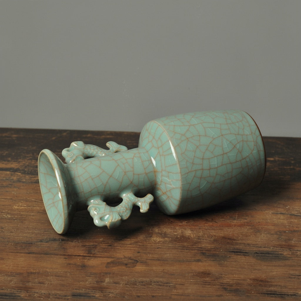 Angled view of the patterned ceramic fish handle vase resting on its side