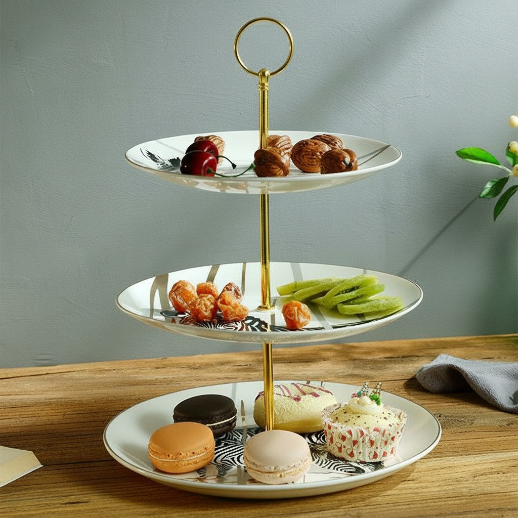 Patterned ceramic three tier serving stand displaying pastries and fruit